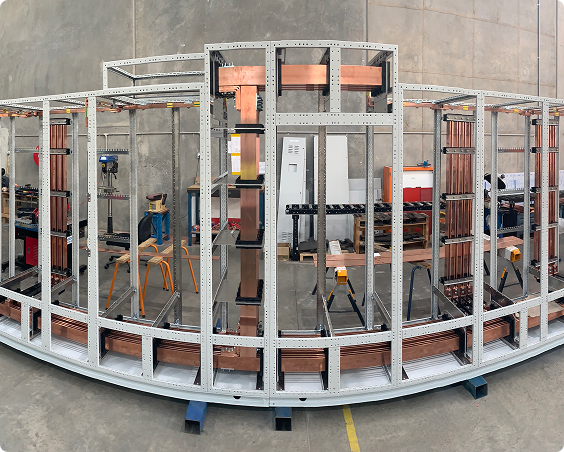 Curved steel switchboard assembly frame in the RMS Manufacturing workshop