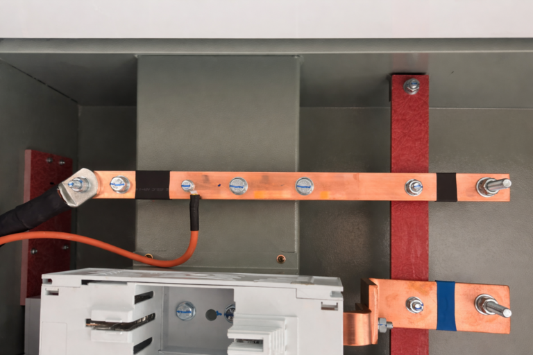 Copper busbars with orange cabling manufactured by RMS Manufacturing