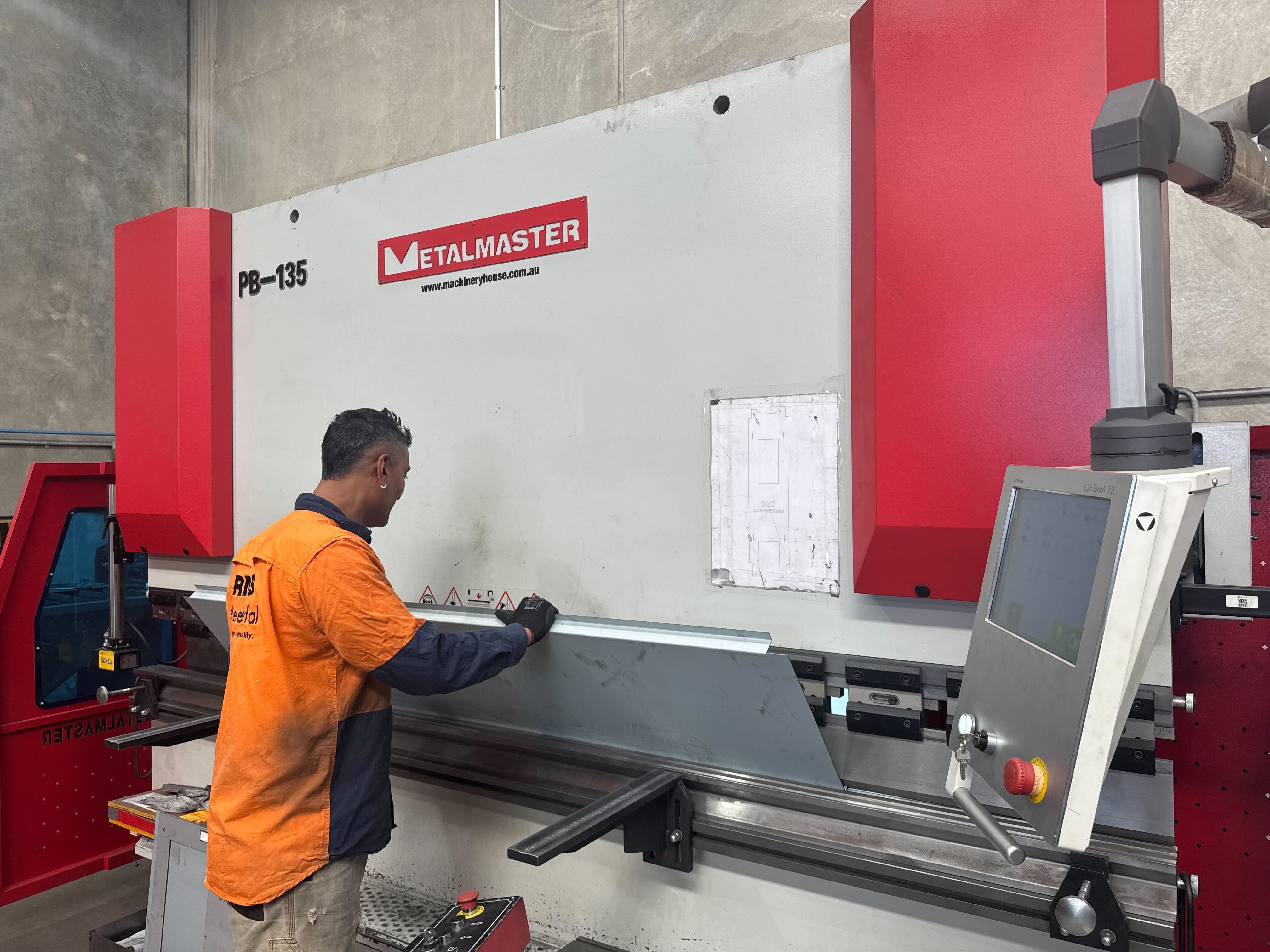 Sheet metal being folded on a press brake at RMS Manufacturing